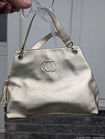 Front view showing gold exterior and interlocking circle logo