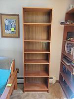 Full view of one bookcase showing height, shelves, finish