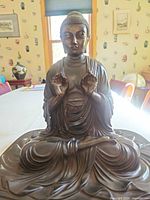 Front view of bronze seated Buddha statue