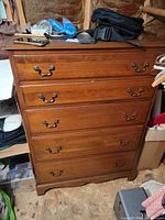 Front view of cherry veneer chest closed