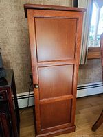 Front view of closed cherry wood CD cabinet