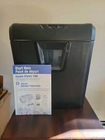 Front view of black Staples shredder with viewing window