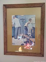 Front view of framed Norman Rockwell print, full frame and mat visible