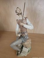 Front view of Lladró Don Quixote figurine showing sword, pose and base details
