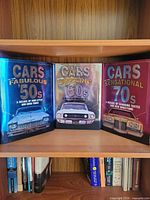 Front covers of three hardcover automotive books