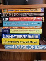 Stack of nine hardcover books showing all spines and titles