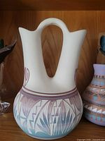 Front view of double-spout wedding vase showing design and colors