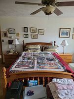 Full view of assembled queen wooden bed frame with light oak finish and spindle design