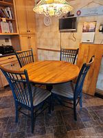 Round wooden dining table and four chairs