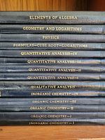 Spine view of stacked volumes showing 13 of the 14 titles