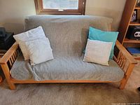 Futon frame in sofa position with throw pillows