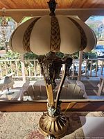 Full view of lamp showing ornate base and frosted glass shade