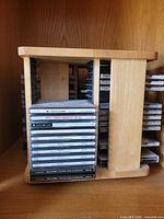 Front view of rotating wood CD rack filled with CDs