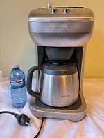 Front view of Breville coffee maker with thermal carafe and power cord
