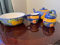 group shot of all four Fruitful ceramic pieces on table