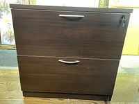 Front view showing two drawers, handles, key in lock