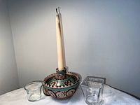 Ceramic candle holder with taper and two glass votives displayed together