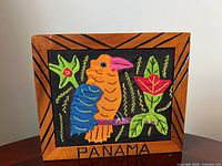 Front view of framed textile artwork showing full design and frame details