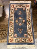 Full view of the blue oriental runner rug on hardwood floor