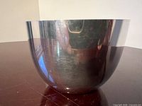 Side view of reflective hemispherical pewter bowl