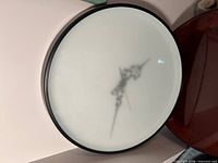 Front view showing frosted glass face and black frame