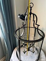 Chandelier on table showing height with tape measure