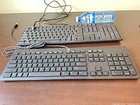 Both keyboards side-by-side showing full layouts and USB cables