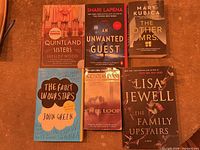 Front covers of six paperback novels