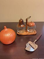 Condiment caddy, orange onion keeper, cheese slicer on table