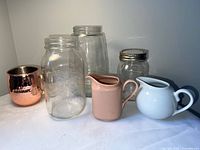 Group shot of all items—copper mug, three mason jars, two ceramic creamers