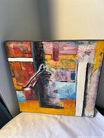 Front view of the abstract painting showing colours and signature