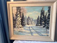 Front view of framed oil painting showing winter landscape scene