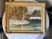 Front view of framed winter river landscape painting