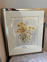 Frontal view of framed watercolor painting showing artwork, mat, and metallic frame
