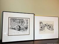 Both framed prints side by side on surface