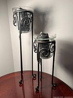 Tall and short candle holders on tabletop