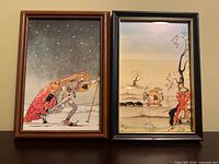 Both framed prints side by side on shelf