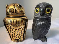 Front view of both owl containers with lids on