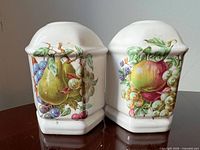 Front view of both shakers showing fruit decals and overall shape