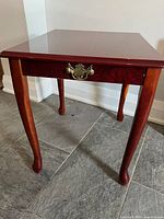 Front view showing drawer and brass pull