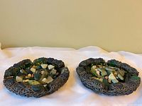 Both ashtrays side by side filled with beach glass, stones, shells