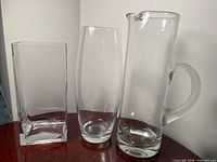 Front view of the three clear glass pieces standing together