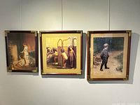 Front view of three framed Paul Peel prints hung side by side