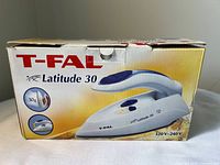 Front of retail box showing model name, dual voltage rating and product image