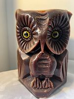 Front view showing carved owl features and eyes