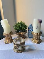 Full set showing two candle holders with candles, planter with greenery, and centerpiece bowl