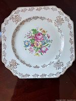 Front view showing floral center motif and gold border