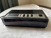 Front view showing LED time display, control panel, and tuner scale