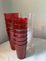 Stacks of red and clear tumblers showing ribbed design