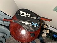 Wilson American Ace Jr. and Wilson Rally Midsize rackets in covers on tabletop